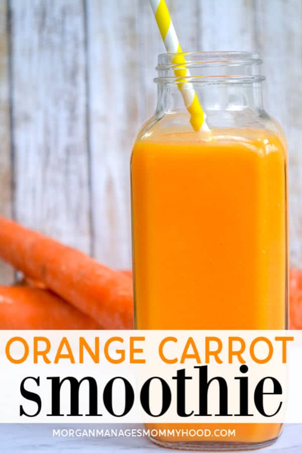 orange carrot smoothie in a glass bottle with a yellow striped straw with carrots in the background