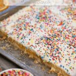 easy lemon bars in a pan with sprinkles and slices of lemon bars taken out