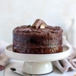 twix cake on a platter with milk and twix bars