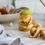 apple pie bites split in half with two stacked behind it