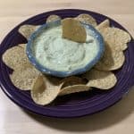 cucumber dip in a bowl served with chips