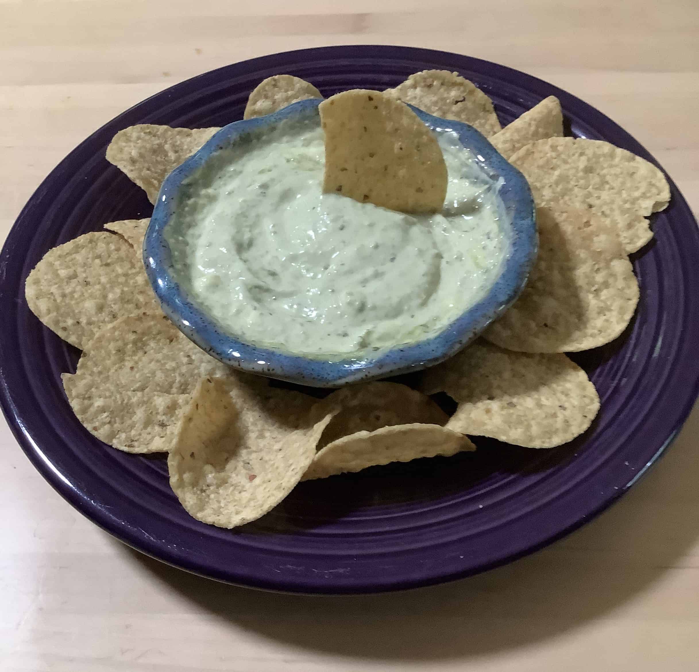 cucumber dip in a bowl served with chips