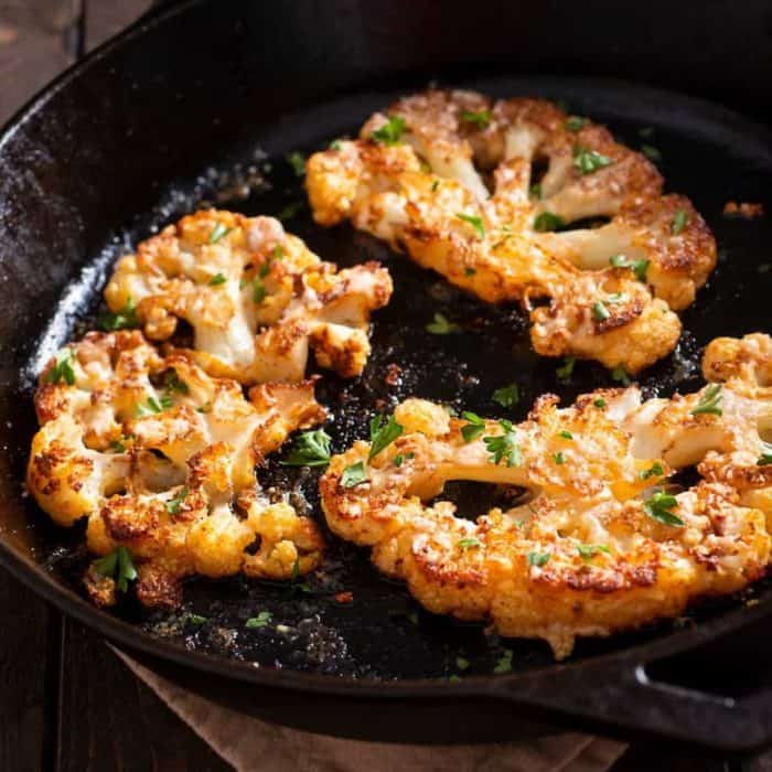 Place the cauliflower steaks on the grill and cook for 5-6 minutes per side, or until they are tender and charred.