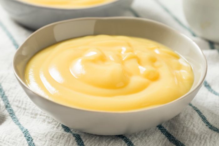 homemade vanilla custard in a bowl placed on a kitchen towel