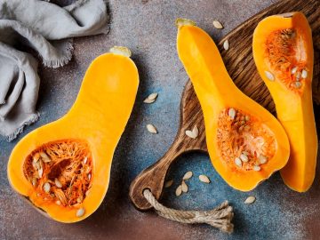 butternut squash on a wooden board against a rustic background