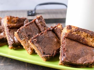Sliced chocolate peanut butter brownies showcase a delightful, enticing contrast of a crunchy crust and tender center, revealing appealing layers of chocolate and gooey peanut butter that will satisfy your sweet tooth.
