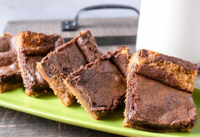 Sliced chocolate peanut butter brownies showcase a delightful, enticing contrast of a crunchy crust and tender center, revealing appealing layers of chocolate and gooey peanut butter that will satisfy your sweet tooth.