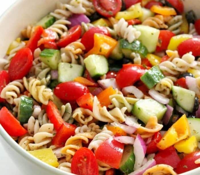 gluten-free vegan Italian pasta salad, drench gluten-free brown rice rotini and crunchy veggies like cucumbers, bell peppers, onions, and grape tomatoes in a zesty homemade Italian dressing.
