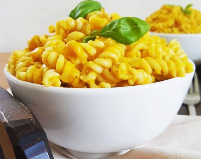 a bowl of gluten free pasta with gluten-free fusilli bathed in a rich, lightly spiced sauce made with pumpkin, red lentils, almond milk, and vegetable broth