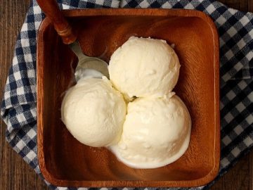 a wooden bowl with Buttermilk ice cream offers a creamy, tangy, and subtly sweet flavor.