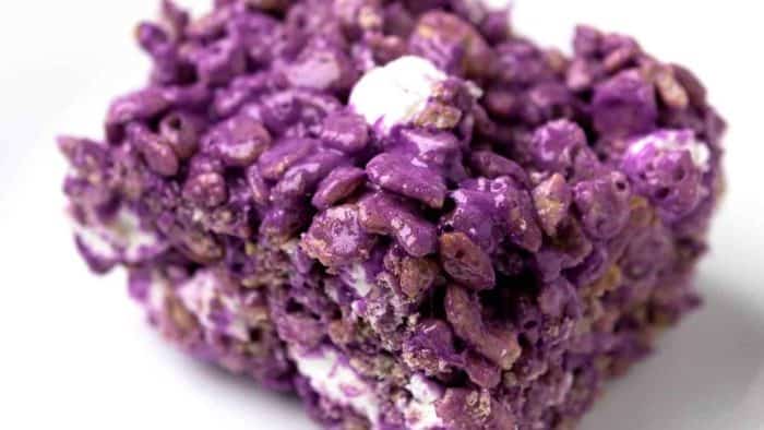 a close up image of purple yam Rice Krispies Treats isolated on white background