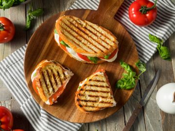 freshly cooked Healthy Grilled Basil Mozzarella Caprese Panini Sandwich placed on a wooden board