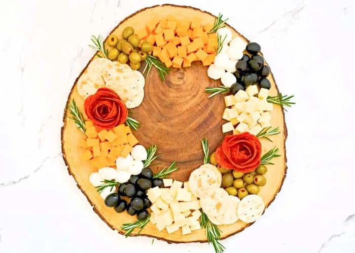 cheeses, meats, olives, crackers, and herbs shaped into a wreath