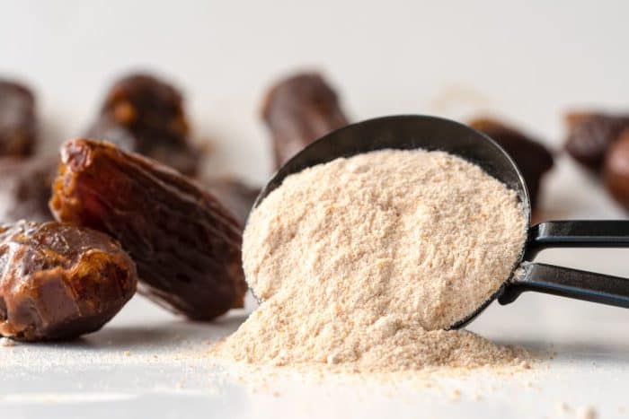 close up image of Date Sugar Spilled from a Teaspoon