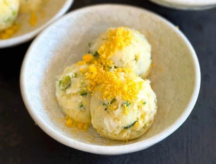 a bowl of Korean potato salad, in which tender potatoes meet a rich medley of eggs and mayonnaise