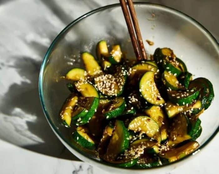 a bowl of Korean zucchini salad topped with sesame seeds