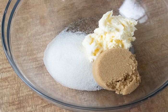 a large mixing bowl with butter with the brown sugar and granulated white sugar.