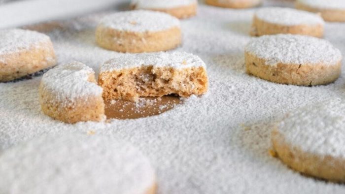 Nestled within a delicate dusting of powdered sugar, these cookies cradle the earthy crunch of walnuts.