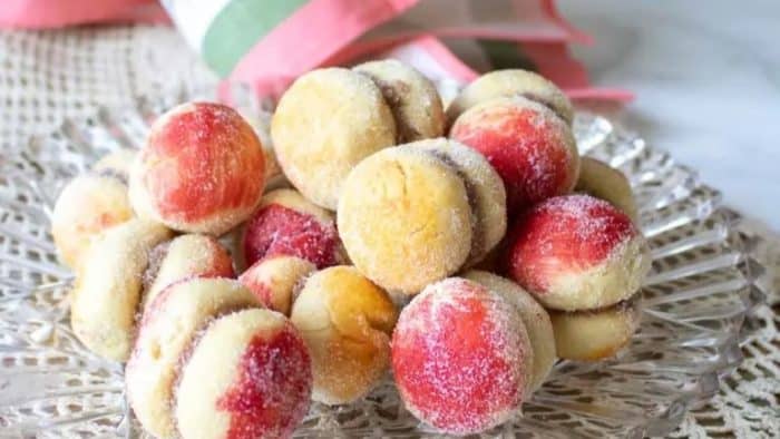 A charming and intricate dessert resembling tiny peaches, these cookies are a celebration of Croatian cuisine. Each is filled with a sweet surprise and delicately colored to mimic the beloved stone fruit.