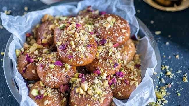 These cookies are soaked in honey and adorned with nuts, offering a sticky, sweet, and spiced experience that's deeply rooted in tradition and perfect for festive occasions.