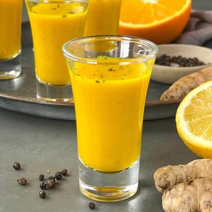 a bunch of ginger turmeric shots on a table