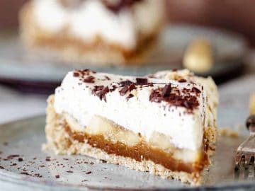 Layers of dulce de leche, sliced bananas, and whipped cream come together atop a crumbly cookie crust in this easy banoffee pie recipe.