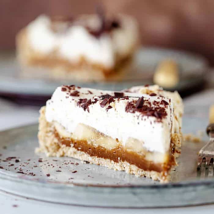 Layers of dulce de leche, sliced bananas, and whipped cream come together atop a crumbly cookie crust in this easy banoffee pie recipe.