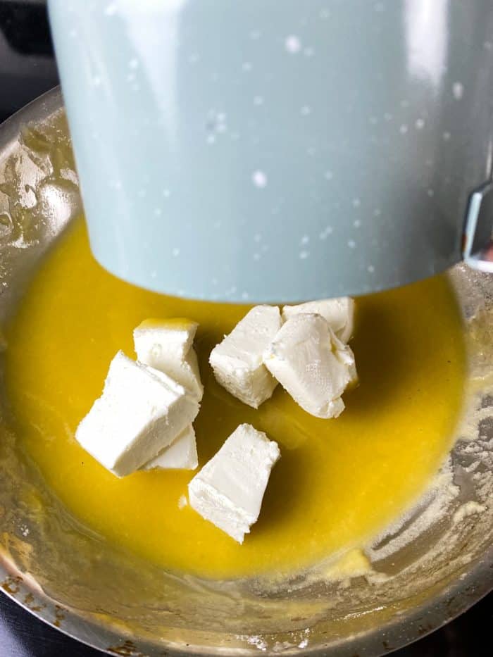 Stir in cream cheese and the garlic-milk mixture until the cheese melts.