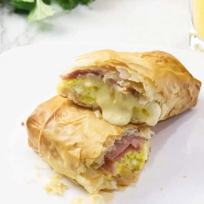 Flaky phyllo dough envelops a savory filling of eggs, ham, and cheese in this sophisticated yet approachable dish!