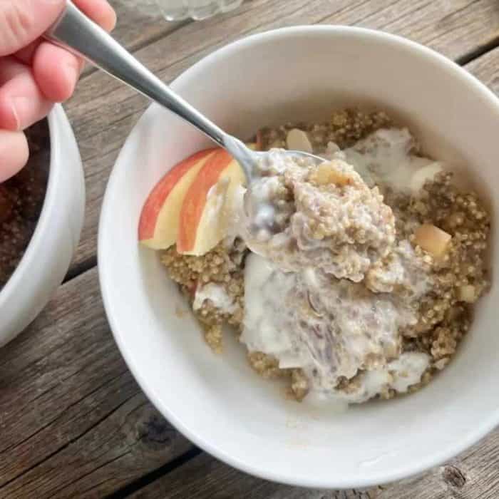 Enjoying this yogurt breakfast bowl offers a great way to start the day, combining protein-rich quinoa, chia seeds, and Greek yogurt with fiber-packed apples for a quadruple punch of nutrition.