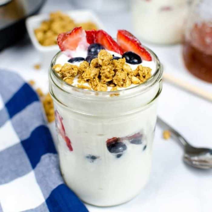 Instant Pot vanilla yogurt in a jar topped with fruits and cereal