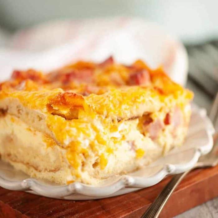 The muffins are topped with ham and drenched in a savory blend of eggs, cheese, milk, and Greek yogurt