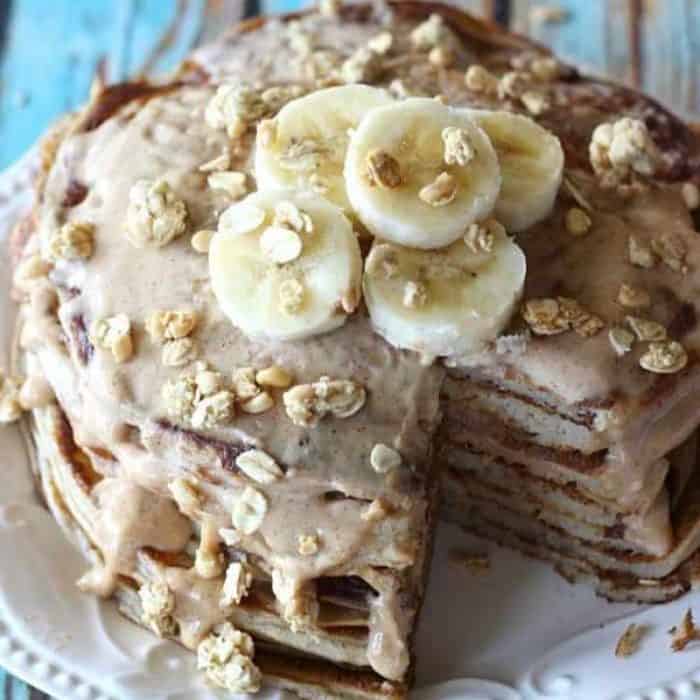 a plate full of delicious pancakes and the glaze in this dish are made with Greek yogurt, boasting a fluffy interior complemented by a rich, nutty almond butter glaze