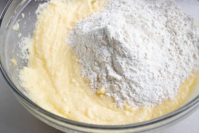 adding flour mixture to the creamy butter base
