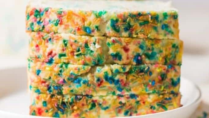 This simple, quirky, and ingenious dessert only requires three ingredients: softened ice cream, self-rising flour, and rainbow sprinkles, which are mixed into a batter and baked for around 40 minutes. 