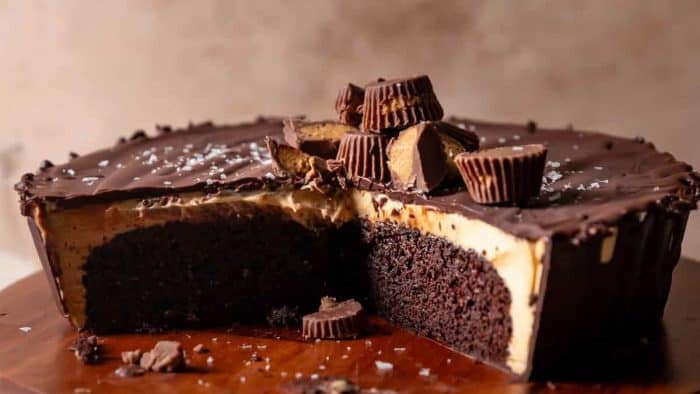  rich chocolate cake, which is paired with a peanut butter mousse, encased in a chocolate ganache, and topped with Reese’s peanut butter cups