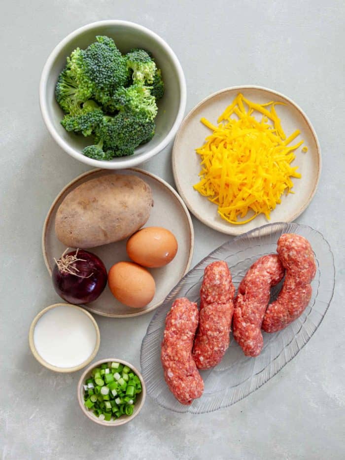 ingredients of sausage and potato casserole on a white table