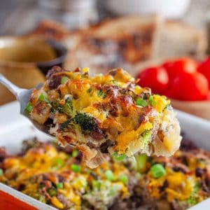 a close up photo of sausage and breakfast casserole on a spoon