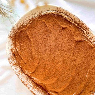 a close up photo of espresso tiramisu in a tub