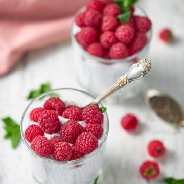 two cups of overnight keto chia pudding on a white table