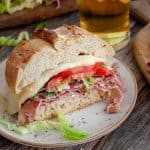 a slice of toasted italian sandwich on a white round plate