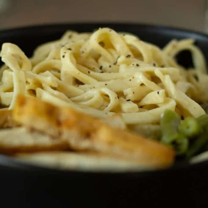 a close up photo of Best Vegan Fettuccine Alfredo  in a pan