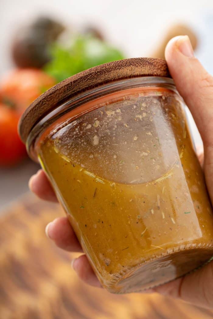 In a salad shaker or jar with a tight-fitting lid, shake together Dijon mustard, maple syrup, red wine vinegar, and olive oil.