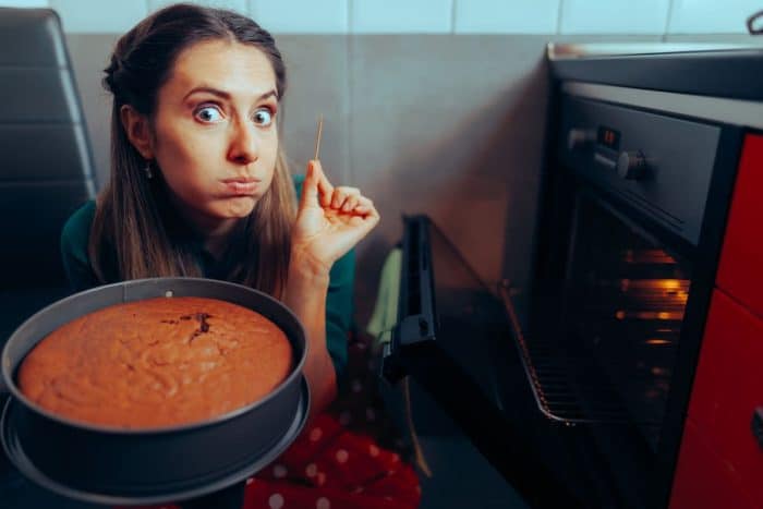 Woman Cooking Using a Toothpick Checking on her Baked Cake