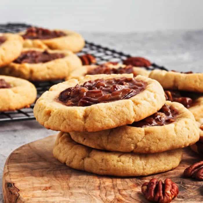 These sumptuously chewy cookies hold a rich, caramelized pecan filling with chopped pecans, reminiscent of the gooey center of a traditional pecan pie. 