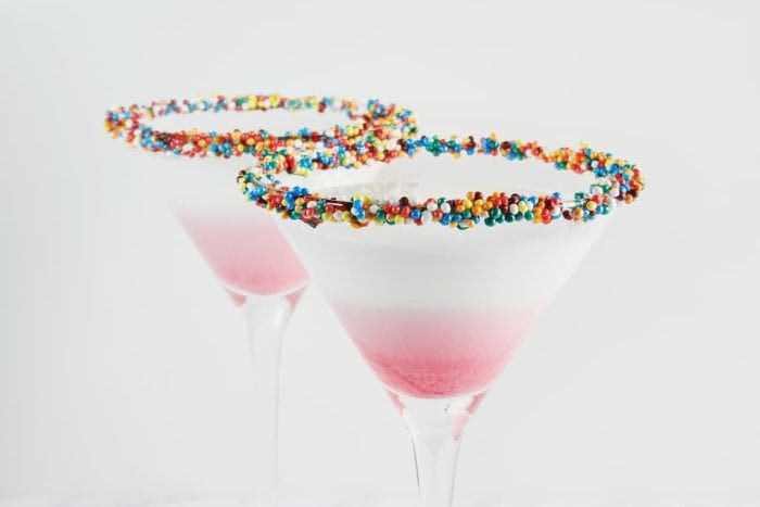 White milk cocktail, close-up. Decorated with jelly hearts.
