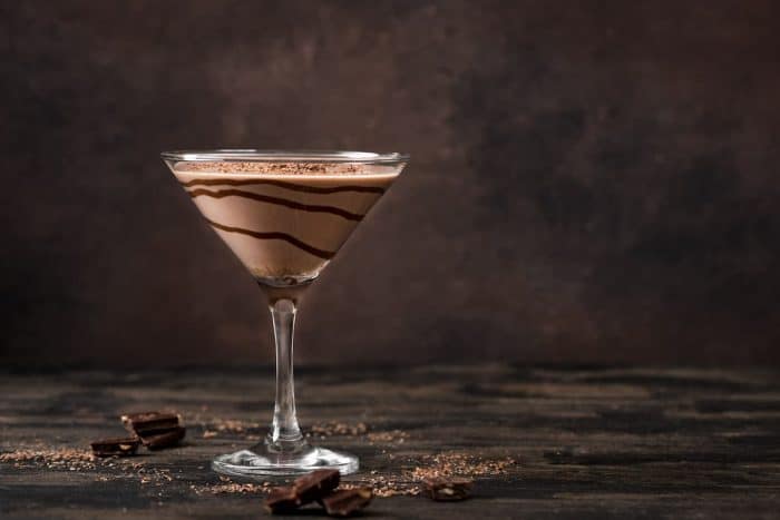 Chocolate Truffle Martini Cocktail on dark wooden background, copy space. Truffletini cocktail recipe.
