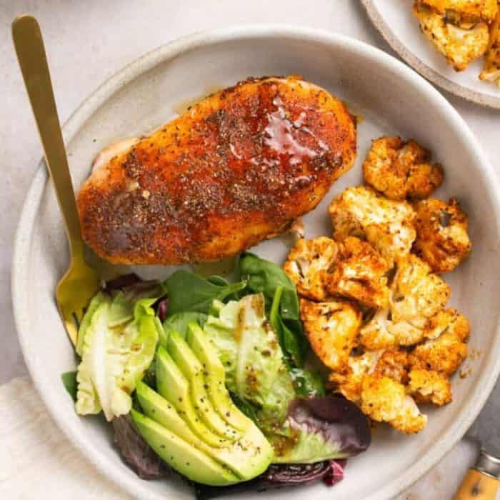 a plate with honey garlic chicken and roasted cauliflower