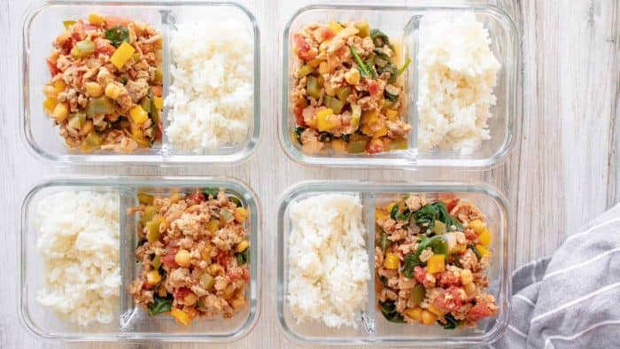 four lunchboxes full of rice with ground turkey