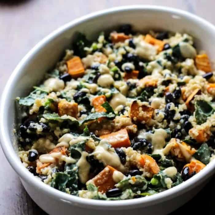 a bowl full of sweet potato, black beans, kale, and quinoa